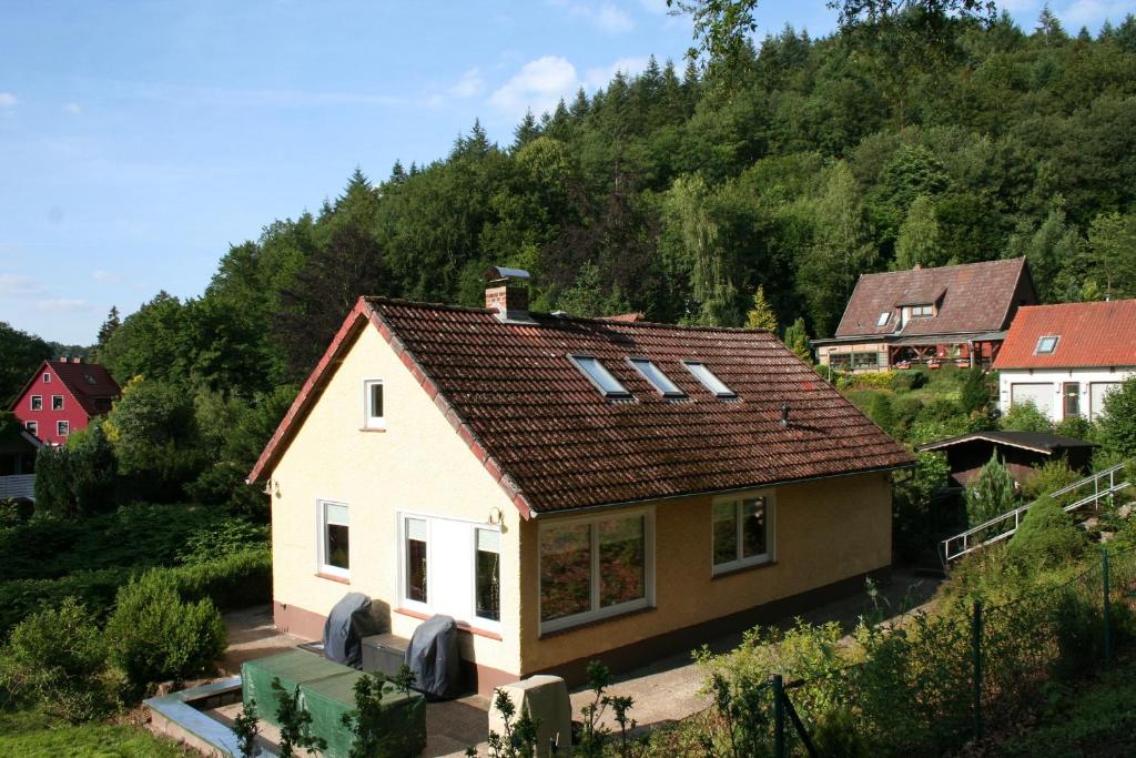 a small white house with a brown roof at Ferienhaus Maria Magdalena in Bad Lauterberg