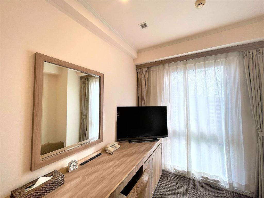 TV a/nebo společenská místnost v ubytování Libre Garden Hotel