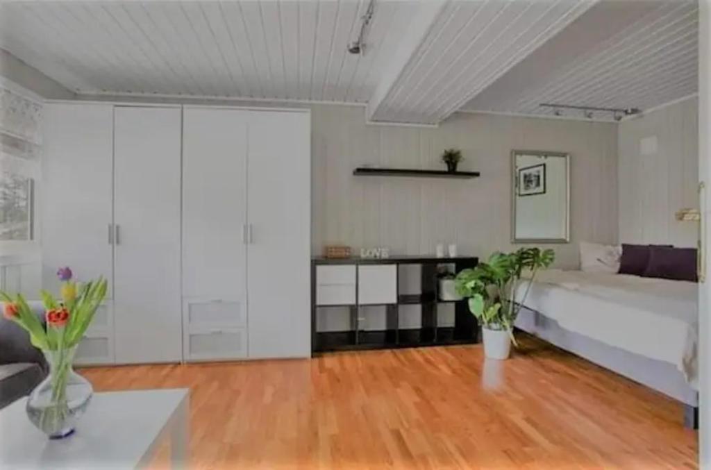 a bedroom with a large bed and a wooden floor at Nice double bed room in Moss in Moss