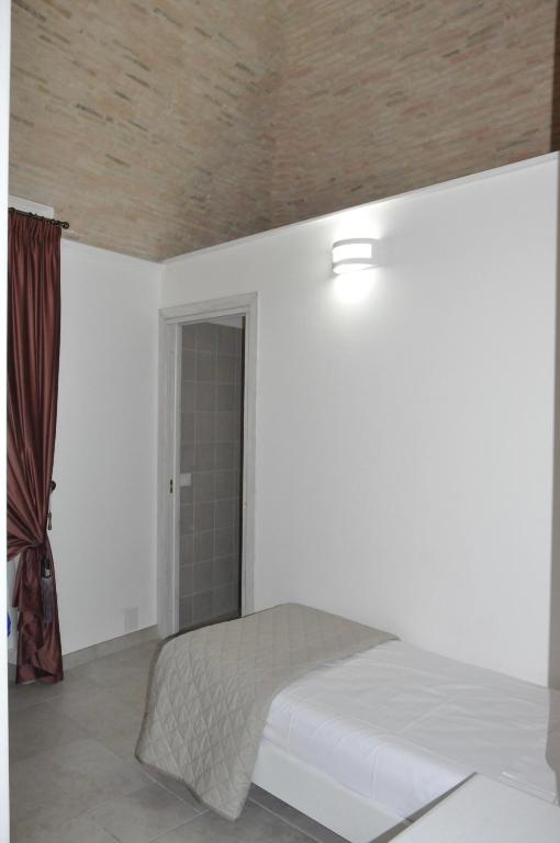 A bed or beds in a room at RELAIS SAN MARCO LUXURY GUEST HOUSE
