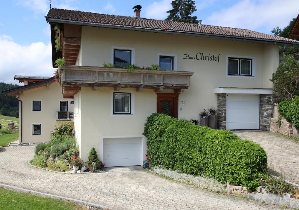 a house with two garage doors in a driveway at Christof,s Ferienwohnung WILD230 in Oberau