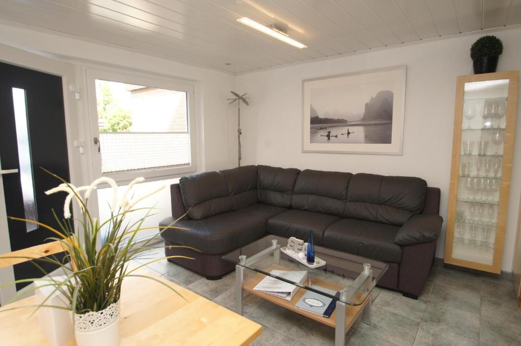 a living room with a leather couch and a table at Koch 1 in Dahme