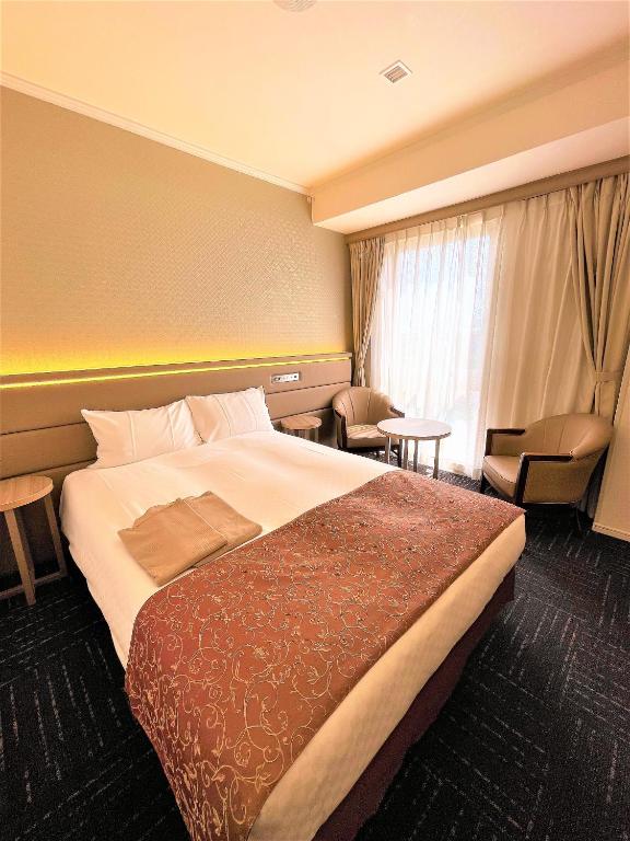 Postel nebo postele na pokoji v ubytování Libre Garden Hotel