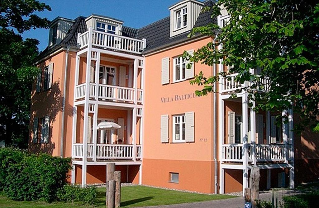 a large orange building with white balconies on it at Villa Balticum, Whg 4 in Zingst