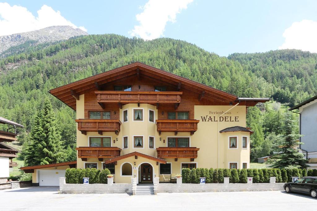 a large building in front of a mountain at Waldele in Sölden