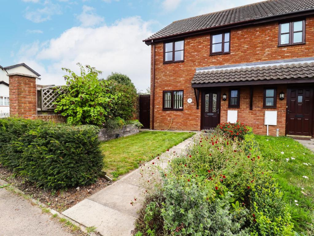 a brick house with a garden in front of it at 1 The Gardens in Stowmarket