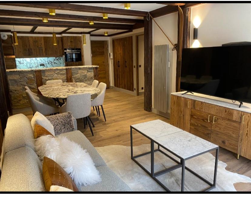 a living room with a couch and a table at Luxury suite 70m2 balcon courchevel1850 parking in Courchevel