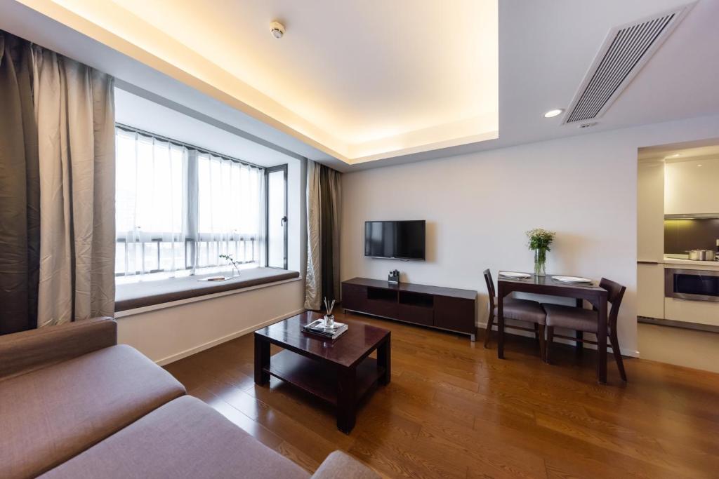 a living room with a couch and a table at Starr Hotel Shanghai (Shanghai Railway Station) in Shanghai