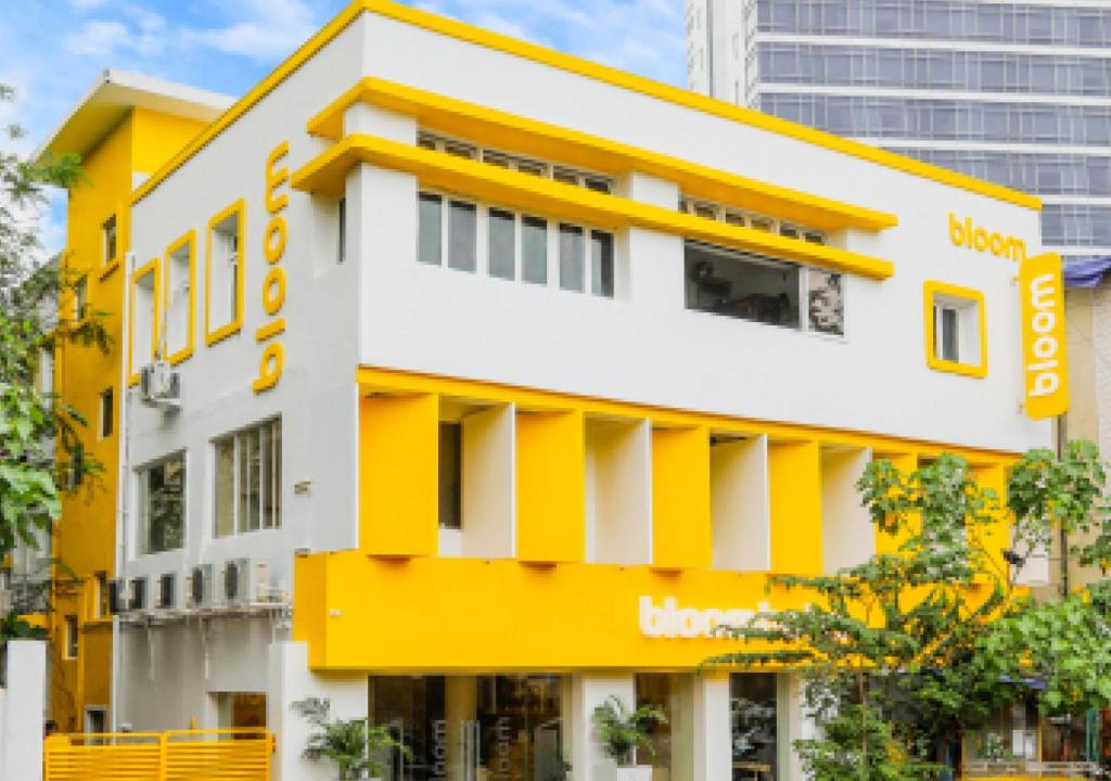 a building with a yellow and white facade at Bloom Hotel - Worli South Mumbai in Mumbai