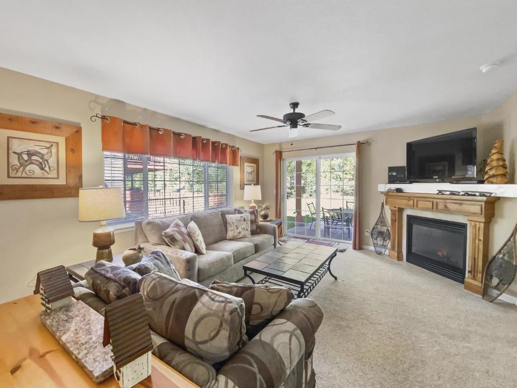 a living room with a couch and a fireplace at Swans Nest Villa 1304 condo in Breckenridge