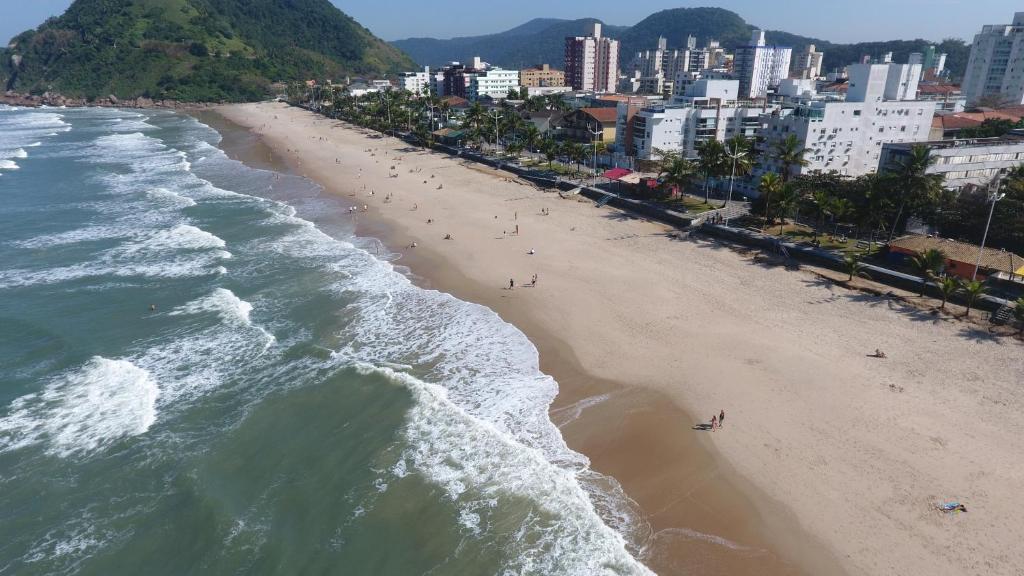 une vue aérienne d'une plage avec des gens dessus dans l'établissement Ap da Mama, à Guarujá