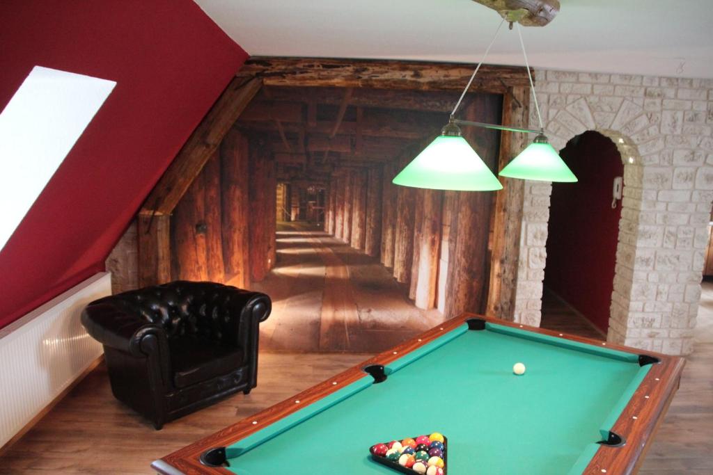 a billiard table in a room with a hallway at Ferienwohnung für bis zu 8 Personen in Sehmatal