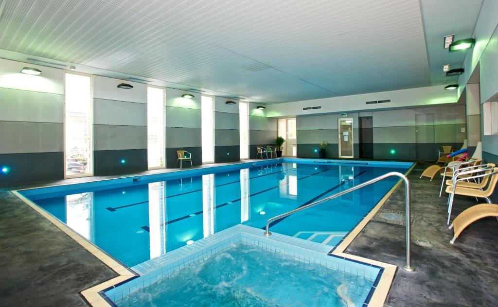 a large indoor swimming pool with a large tub at Brooklands Of Mornington in Mornington