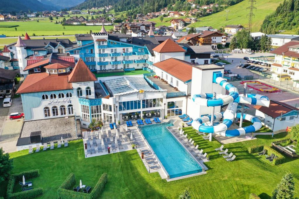 an aerial view of a resort with a water park at Schlosshotel Lacknerhof in Flachau