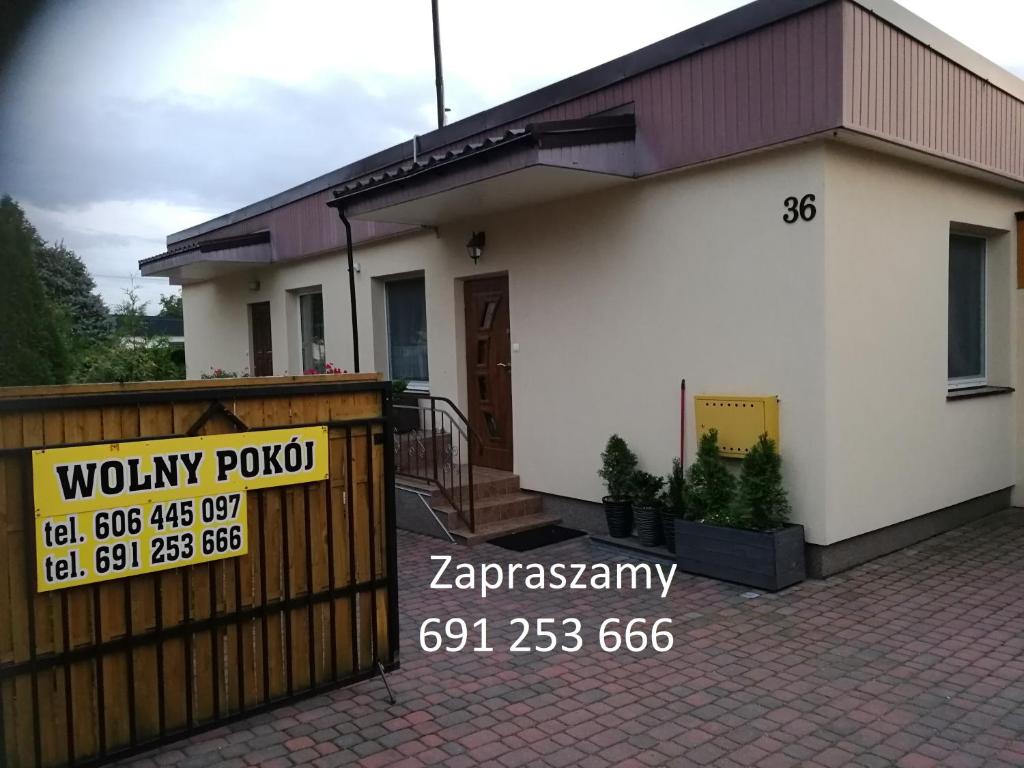 a house with a price sign in front of it at Domek Całoroczny Aga in Mikołajki