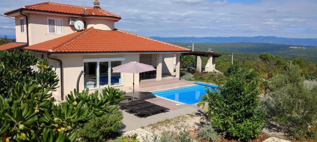 a villa with a swimming pool and a house at Villa Veglia in Krk