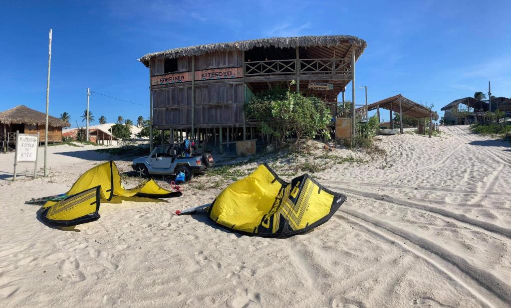 a group of tents on the sand in front of a building at Casa tartaruga in Castelhanos