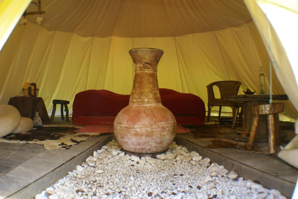 a large vase sitting on a table in a tent at Le Refuge du Clos du Moulin in Brionne
