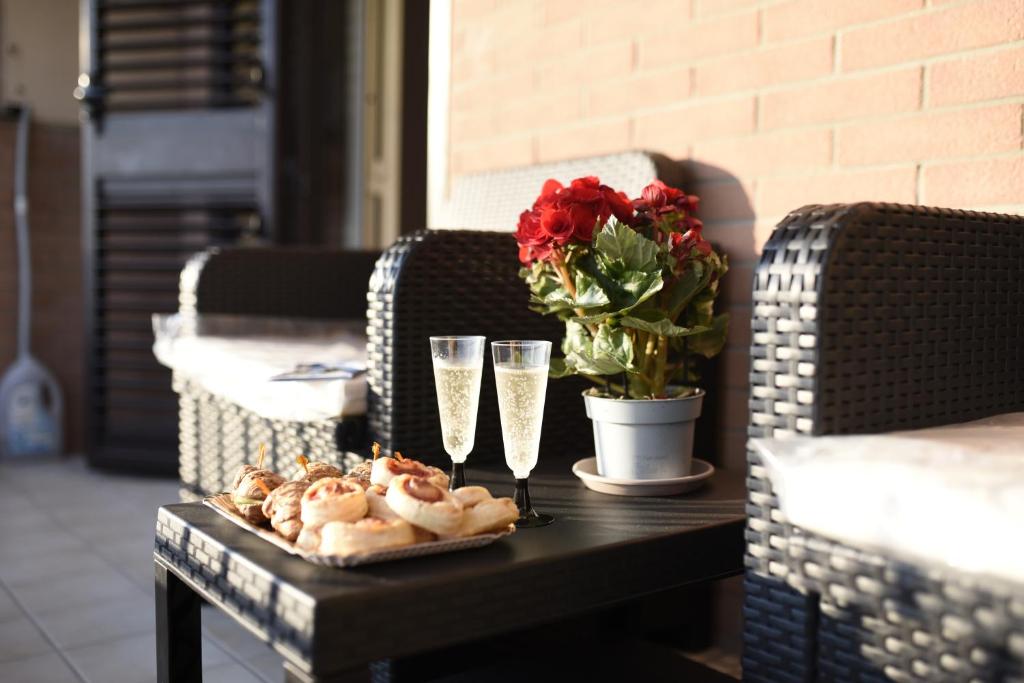 a table with a tray of food and glasses and flowers at SOLE e MARE Luxury Home in San Salvo