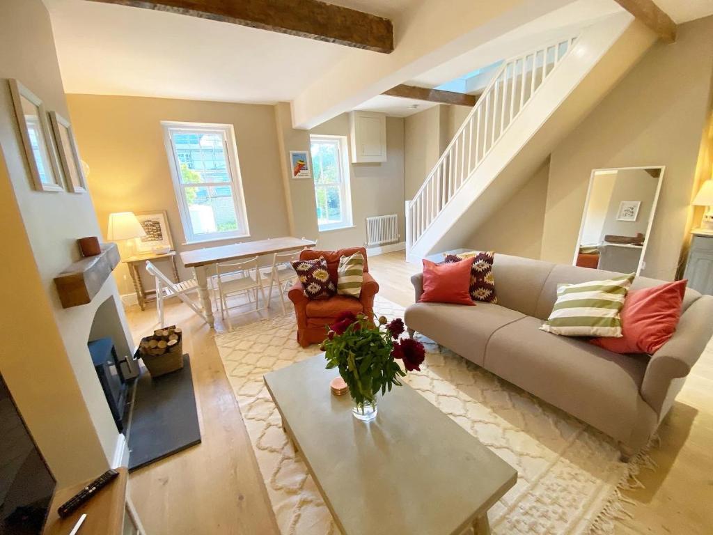 a living room with a couch and a table at Relaxing holiday cottage in the beautiful Usk Valley in Usk