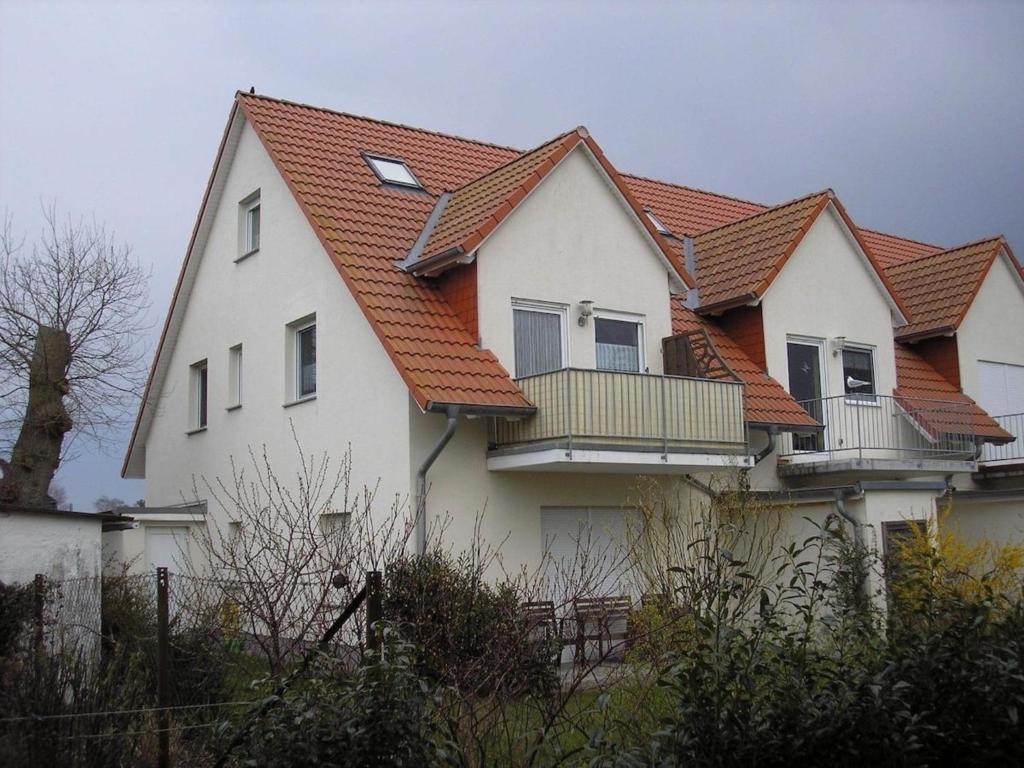 a white house with an orange roof at Ferienwohnung Möwe - a09392 in Zingst