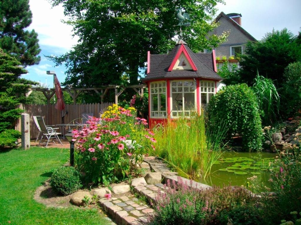 ハイリゲンハーフェンにあるFerienwohnung mit Ostseeblickの庭の池のある小屋
