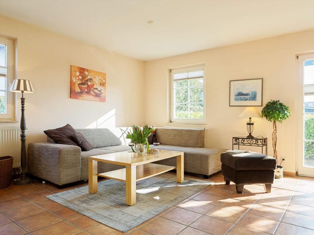 a living room with a couch and a table at Müggenburger Weg 1 Whg 1 in Zingst