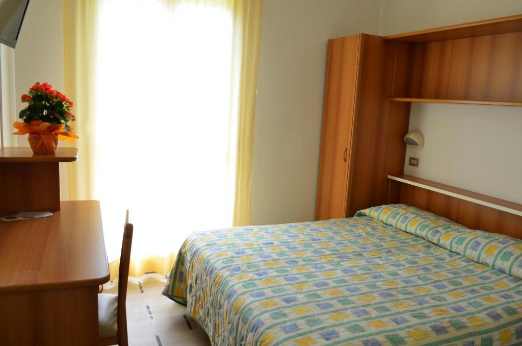 Postel nebo postele na pokoji v ubytování Hotel Zani
