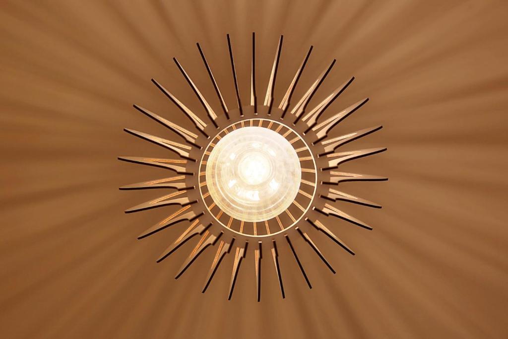 a ceiling light with a sunburst design at Ares Suites in Plataria