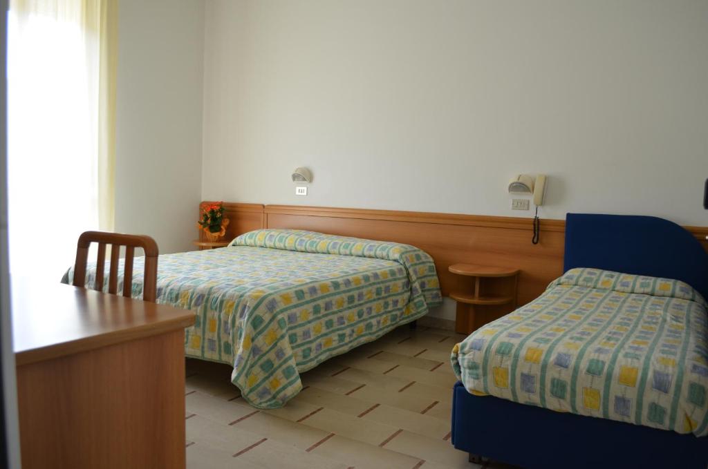 Postel nebo postele na pokoji v ubytování Hotel Zani