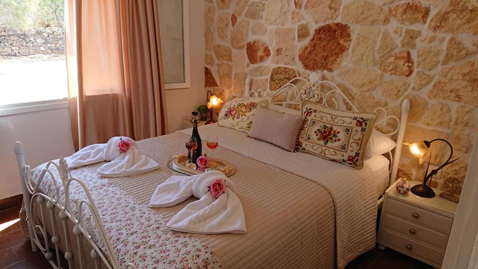 a bedroom with a bed with towels on it at Villa Trypitos in Sitia