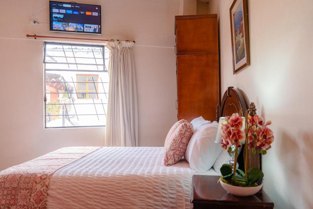 Postel nebo postele na pokoji v ubytování Rincón Familiar Hostel Boutique
