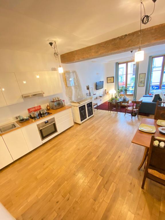 a large kitchen and living room with a wooden floor at Beautiful appartment in the heart of Paris in Paris