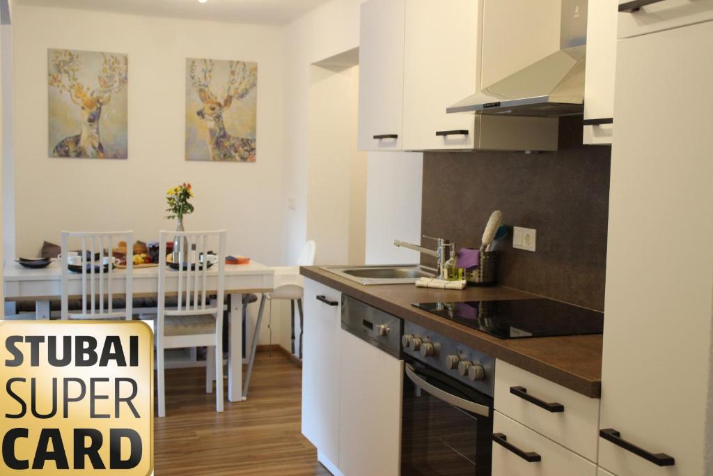 a kitchen with a sink and a stove top oven at Landhaus Klara in Neustift im Stubaital