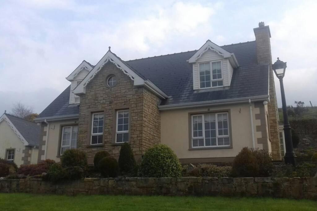 a brick house with a black roof at Drumgowan House in Donegal