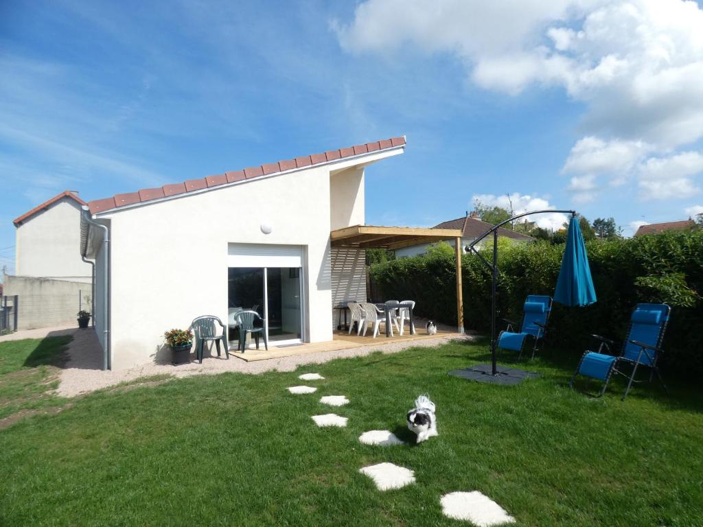 a dog laying on the grass in a yard at gite de la libellule in Commentry