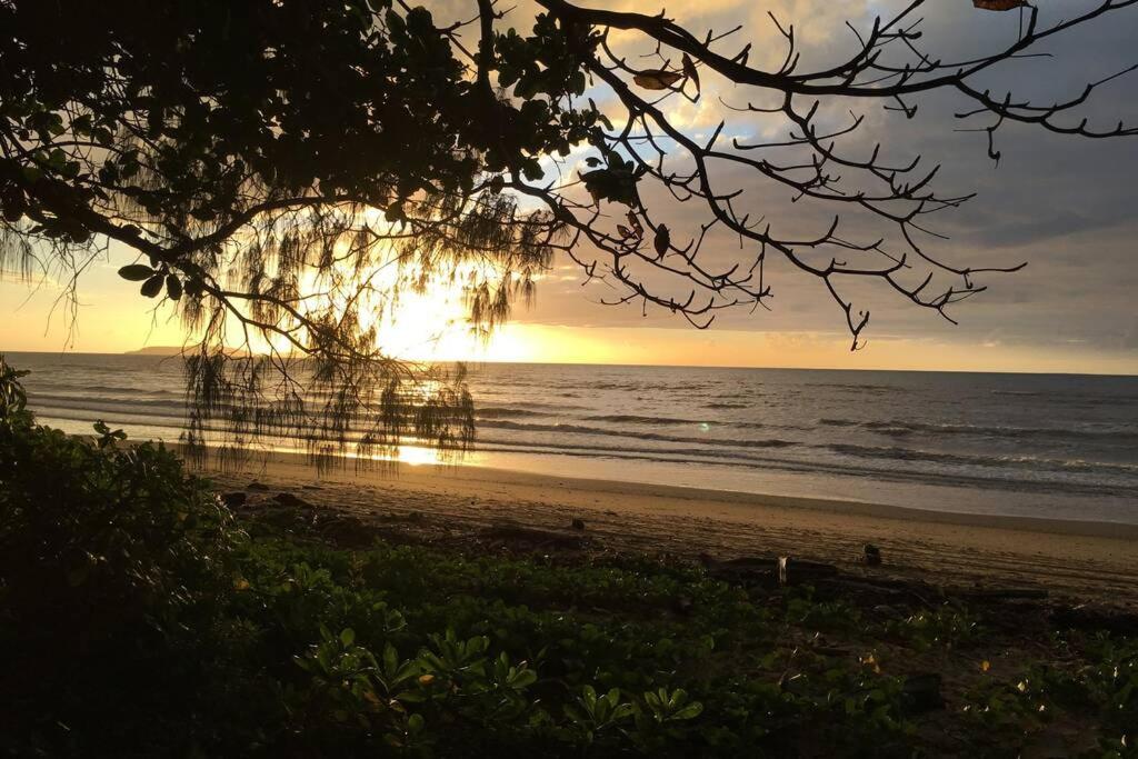 un tramonto su una spiaggia con il tramonto di Daintree Beach Studio - BEACH FRONT ACCOMMODATION a Wonga