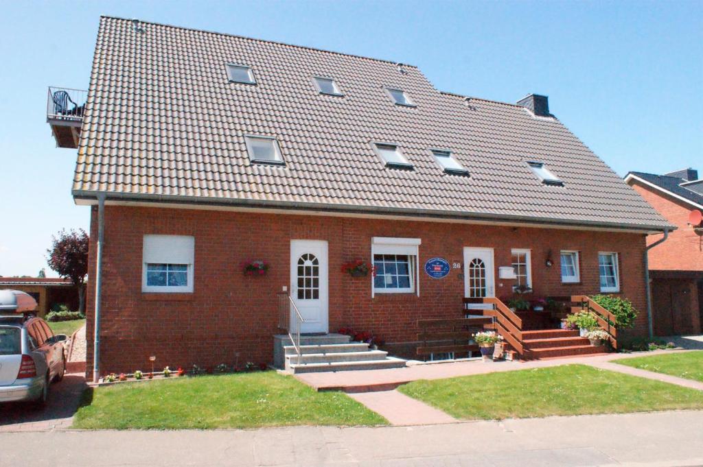 a red brick house with a white door at Haus Swantje - Fewo 1 in Dahme