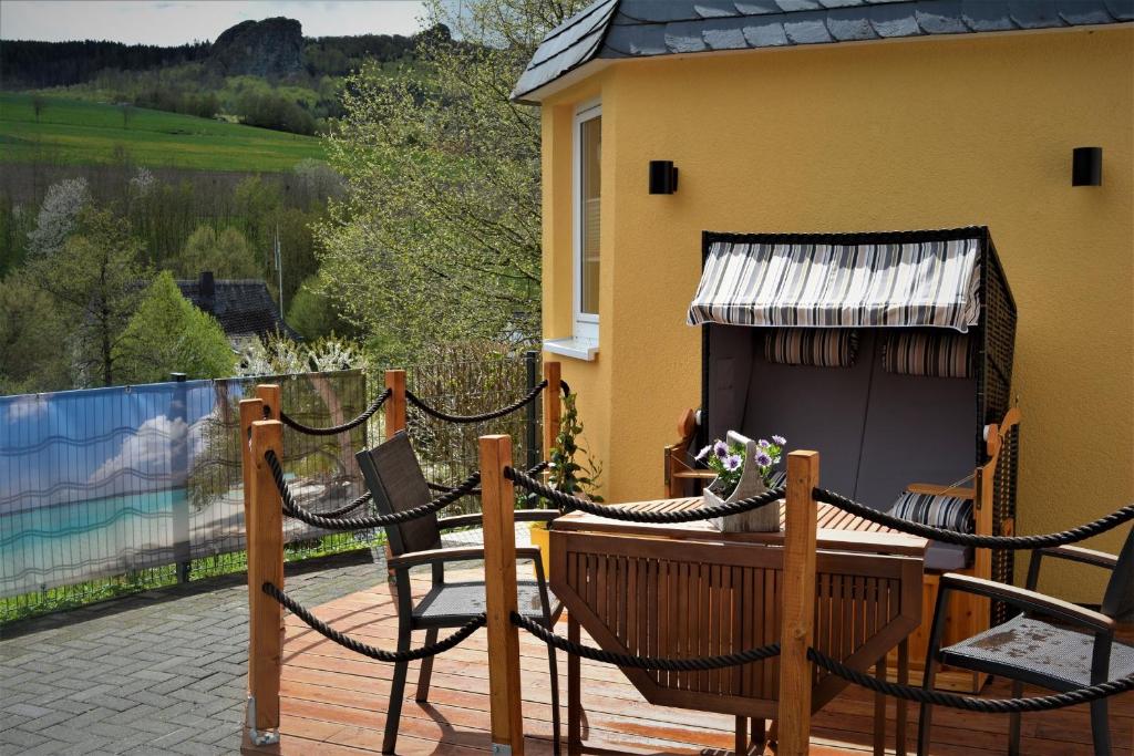 a pair of chairs and a table on a deck at Auszeitoase in Olsberg