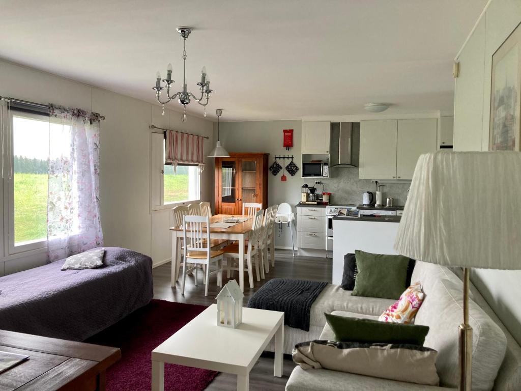 a living room with a couch and a table at Huoneistomajoitus Koto, LaatuLomat in Juva