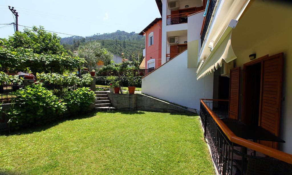 a balcony of a building with a grass yard at Nama Apartments in Skala Potamias