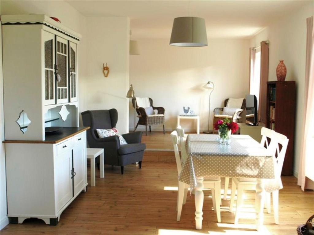 a living room with a table and a dining room at Zeitweise in Bünsdorf