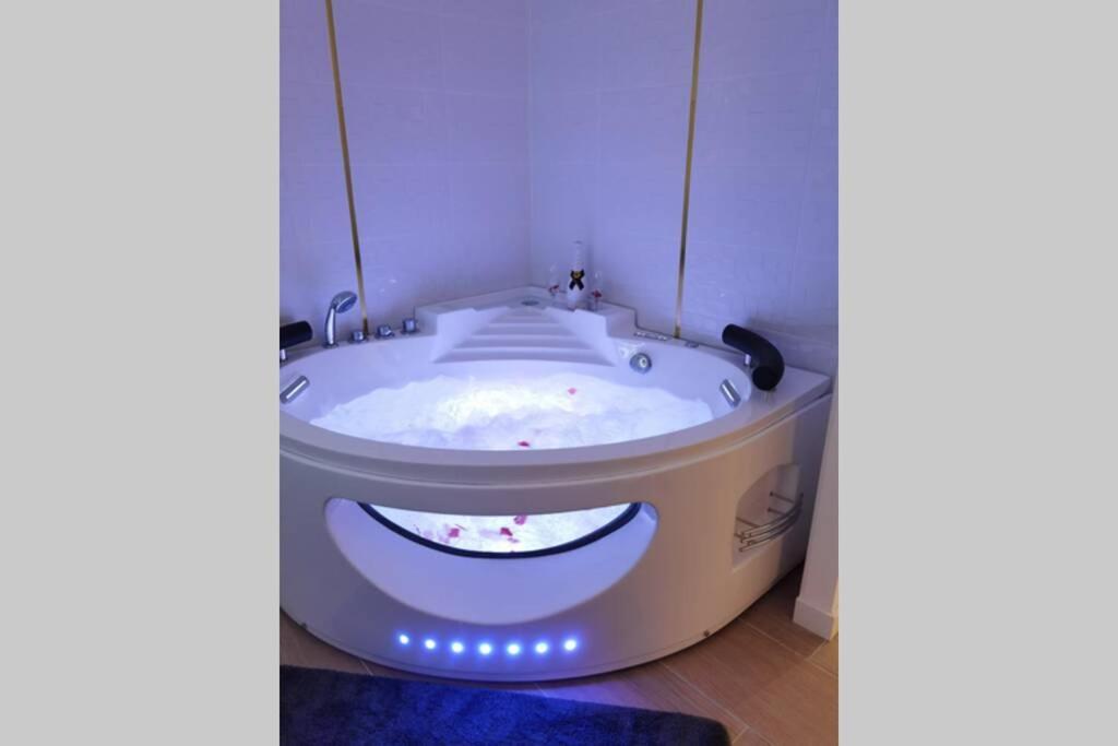 a bath tub with a smiley face painted on it at Nid d'amour baignoire/jacuzzi in Nice