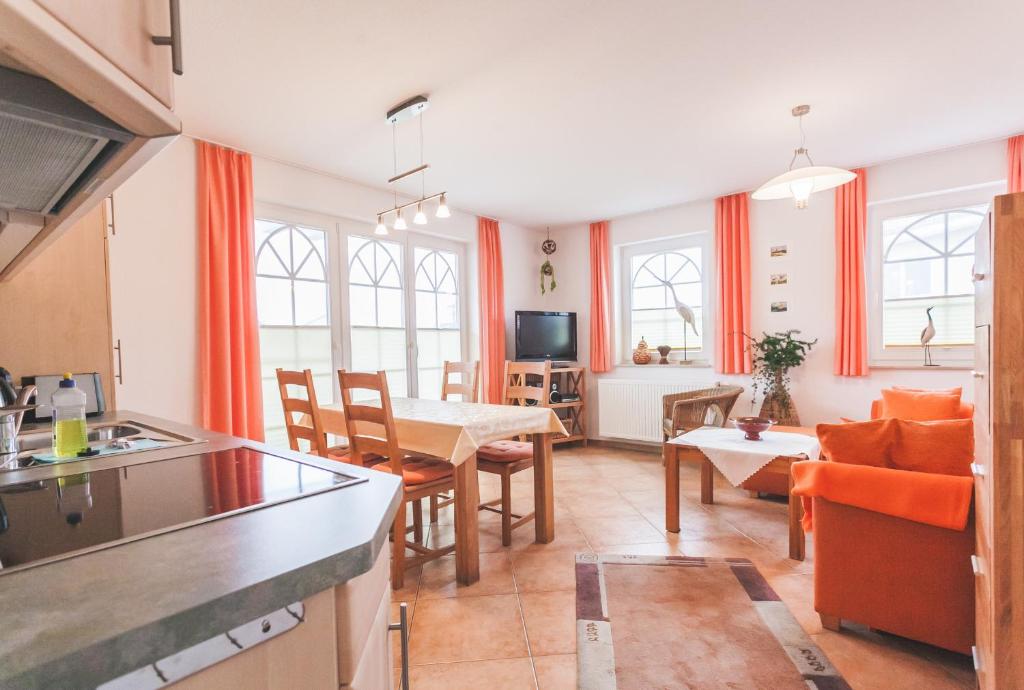 a kitchen and a living room with a table at Fritz-Reuter-Straße 2 Whg 2 in Zingst