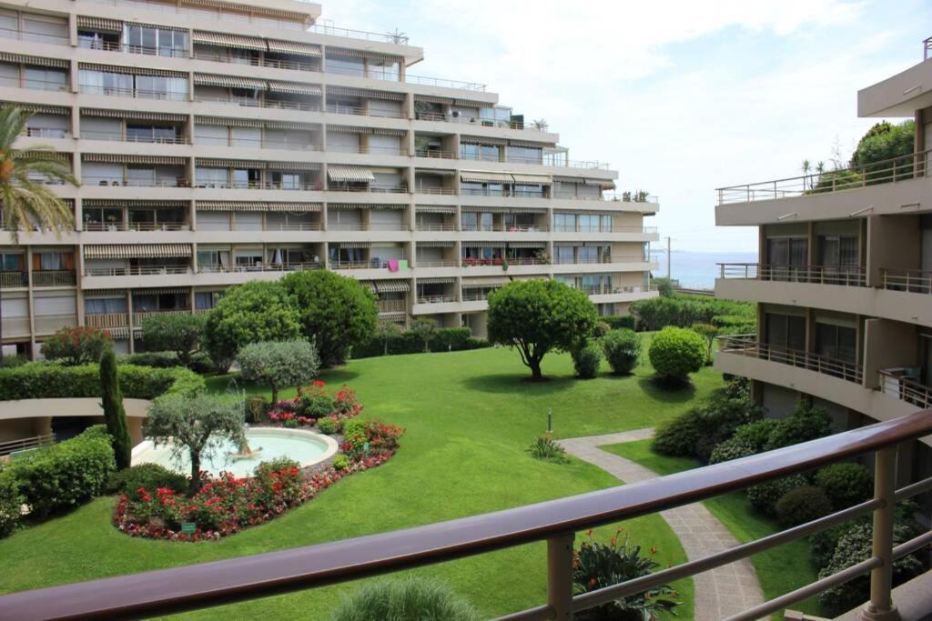 Hotel Studio bord de mer, a large apartment building with a garden in front of it at Studio bord de mer in Cannes