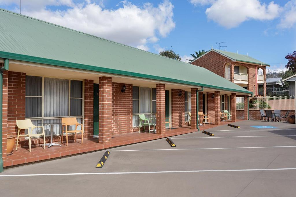 a building with a tennis court in front of it at The Roseville Apartments in Tamworth