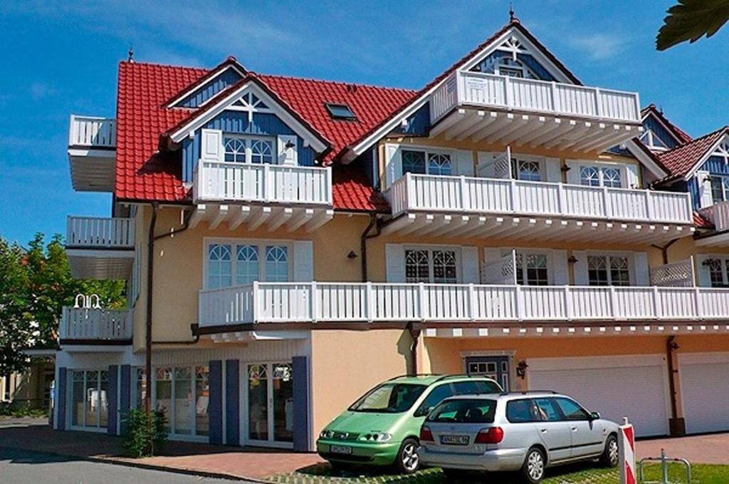 a house with two cars parked in front of it at Villa Sonnenuhr, FW 8 in Zingst
