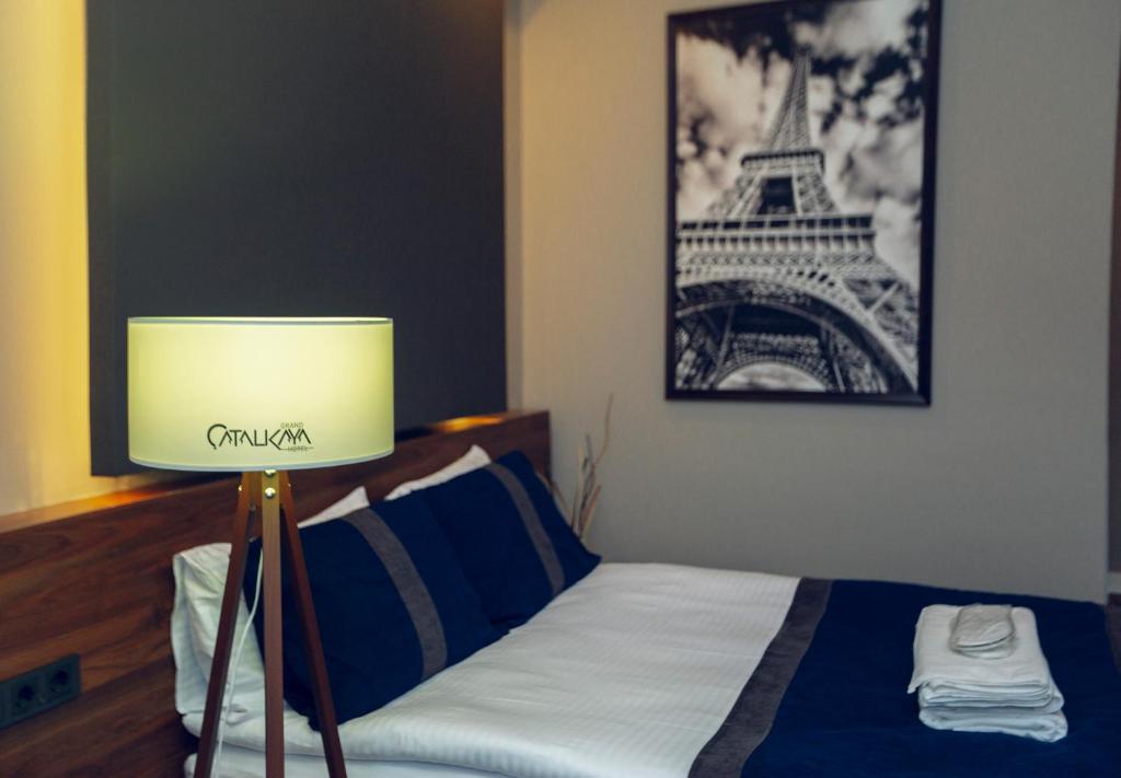 A bed or beds in a room at Grand Catalkaya Hotel