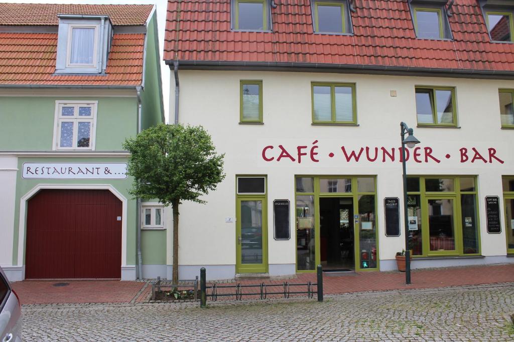 a white building with a cafe winter bar sign on it at Zaunkönig in Bad Sülze