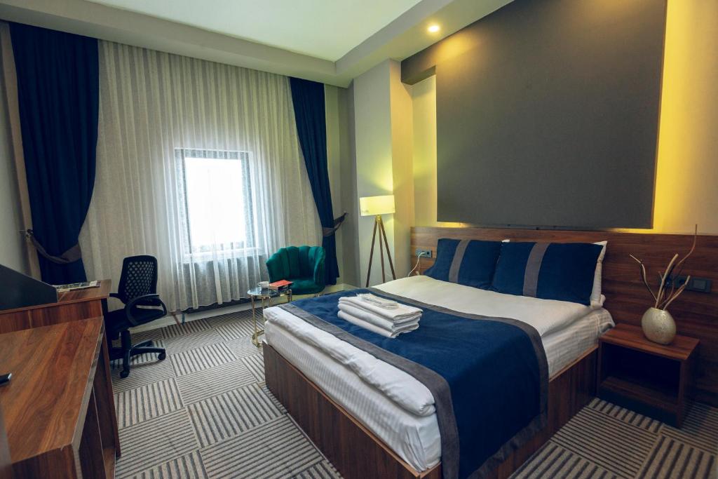 A bed or beds in a room at Grand Catalkaya Hotel